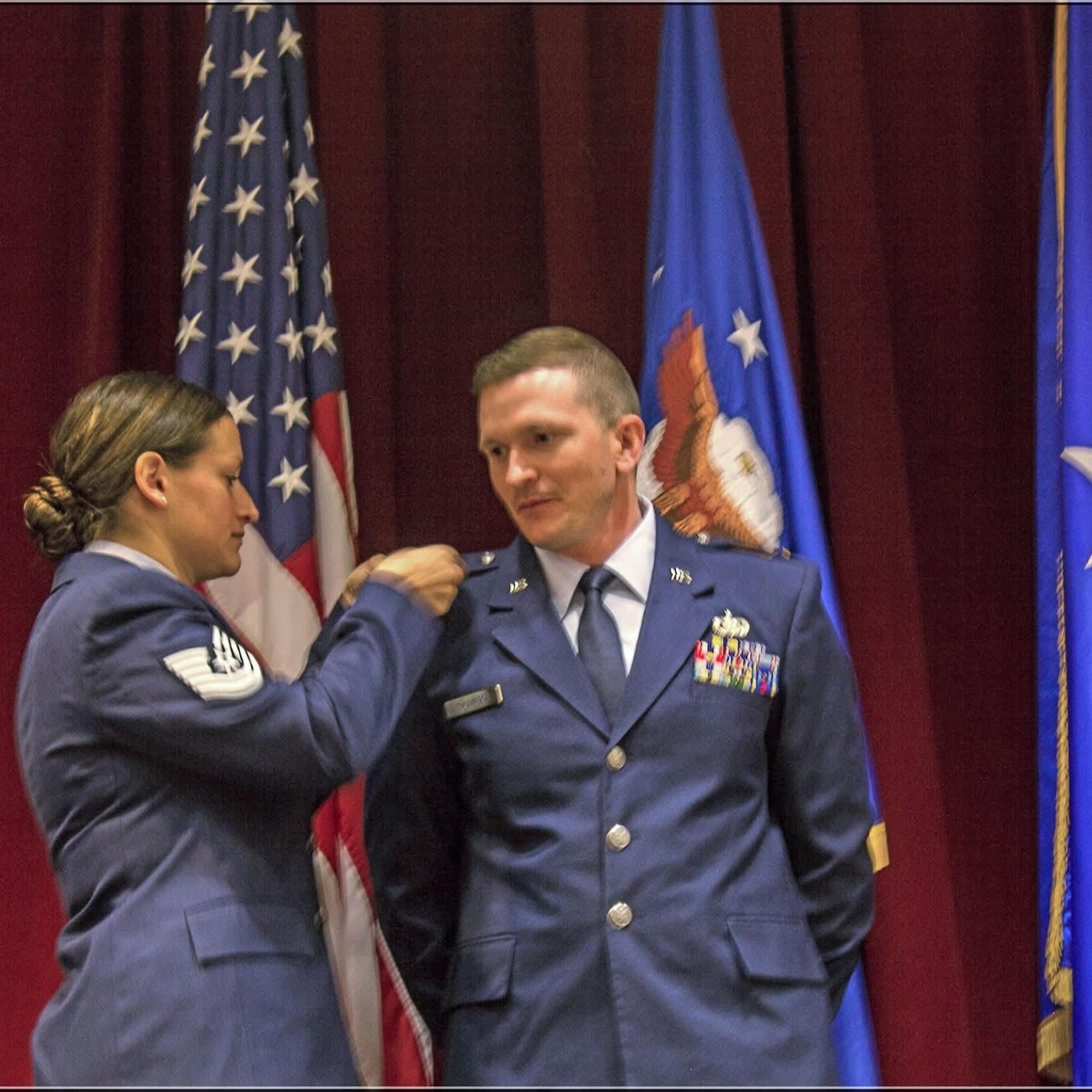 Larry Thompson receiving his first salute as a commissioned Air Force officer from his wife, Elise.